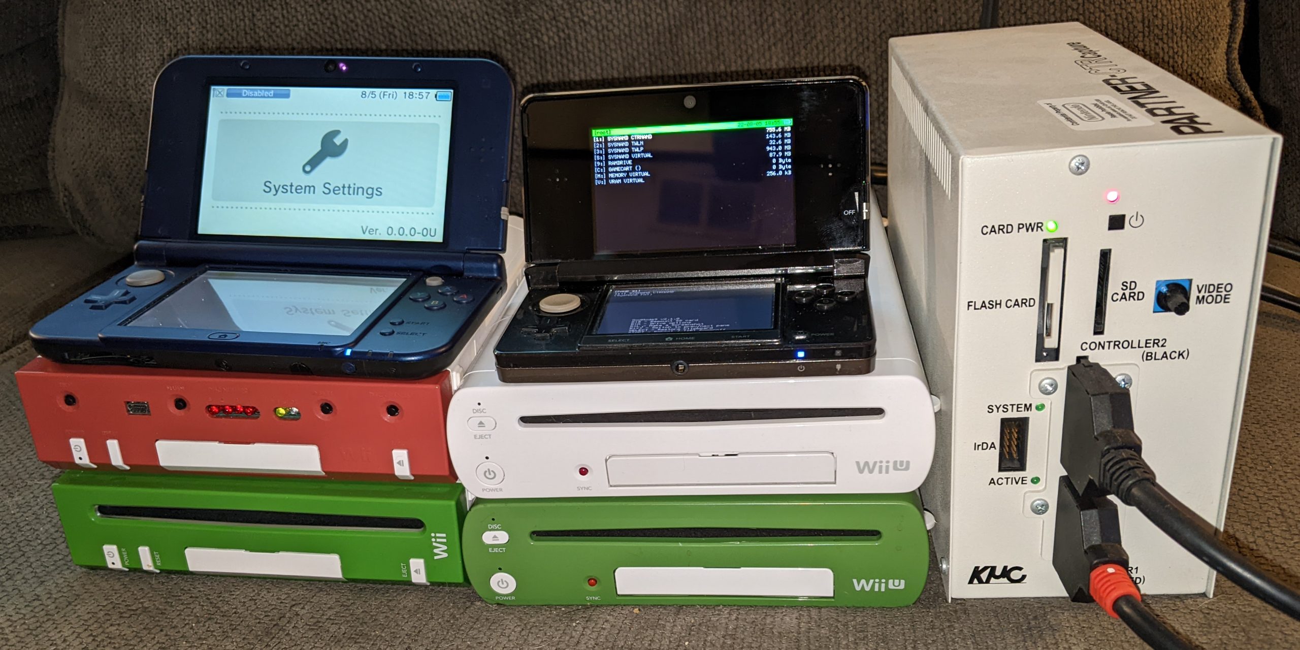 An assortment of Nintendo development kits. Clockwise from the top-left: New Nintendo 3DS XL "Panda", PARTNER-CTR Debugger, CAT-I kiosk unit, CAT-R Reader, RVT-R Reader, RVT-H Reader.